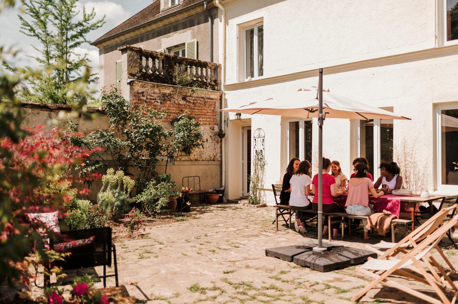 Terrasse extérieur avec des personnes assises à une table lors du séjour parent enfant